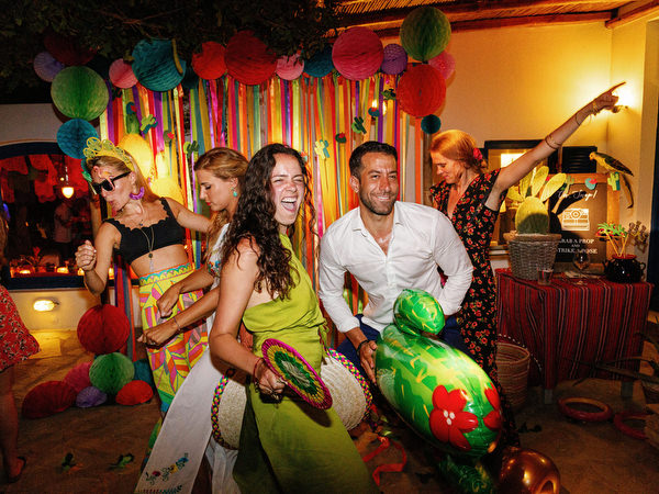 Friends dancing and celebrating during Mexican fiesta pre-wedding party
