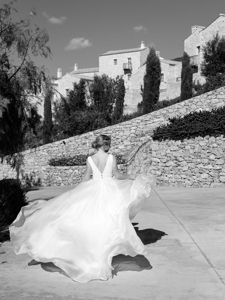 Bride twirling in flowing gown at Aria Estate Greece