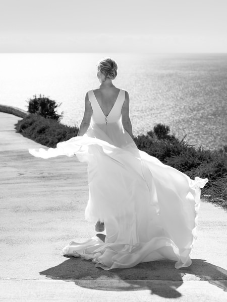 Black-and-white bridal portrait overlooking the sea at Aria Estate in the Peloponnese