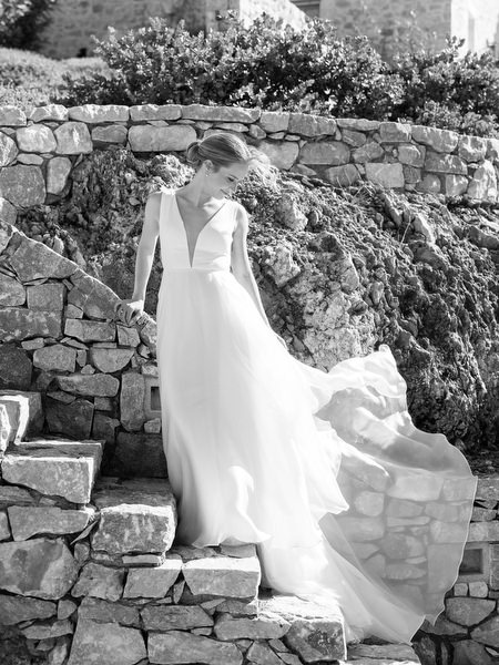 Bride on stone staircase at Aria Estate in the Peloponnese