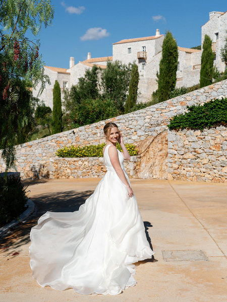 Bride walking through Aria Estate wedding venue in the Peloponnese, Greece