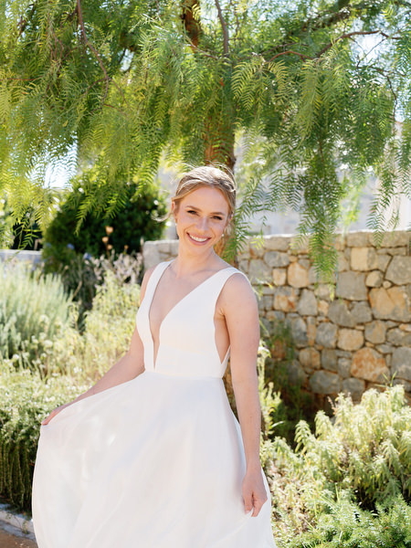Sunlit bridal portrait at Aria Estate destination wedding in Greece