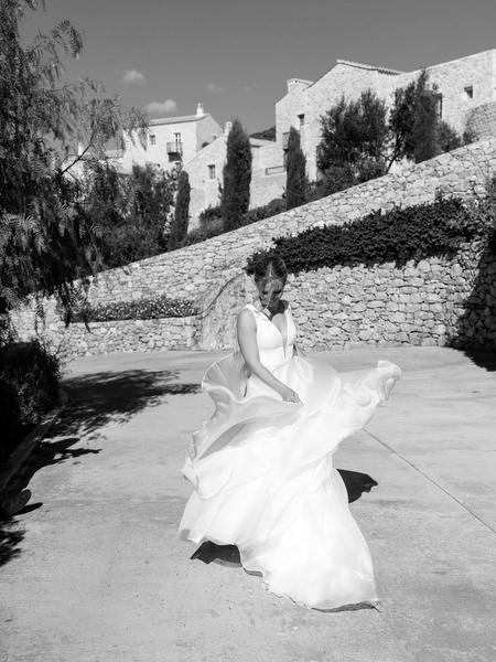 Black-and-white bridal movement at Aria Estate stone courtyard