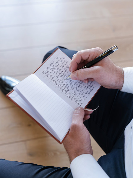 Groom closeup writing wedding vows at Aria Estate in the Peloponnese