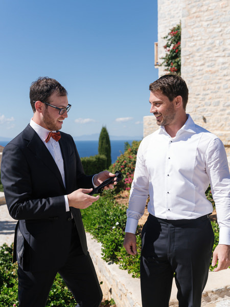 Groom and groomsman preparing at Aria Estate wedding venue in the Peloponnese
