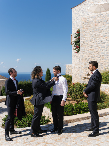 Groom getting ready outdoors at Aria Estate destination wedding in Greece
