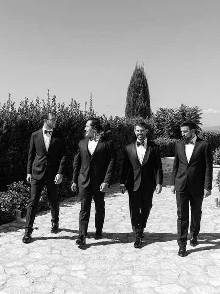 Groomsmen walking through Aria Estate courtyard in the Peloponnese
