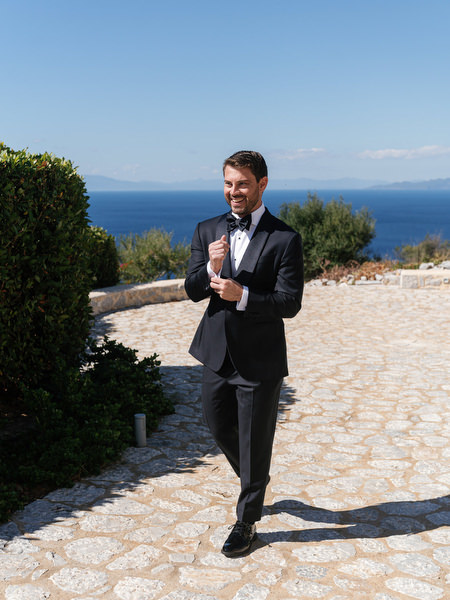 Groom portrait overlooking the sea at Aria Estate in the Peloponnese