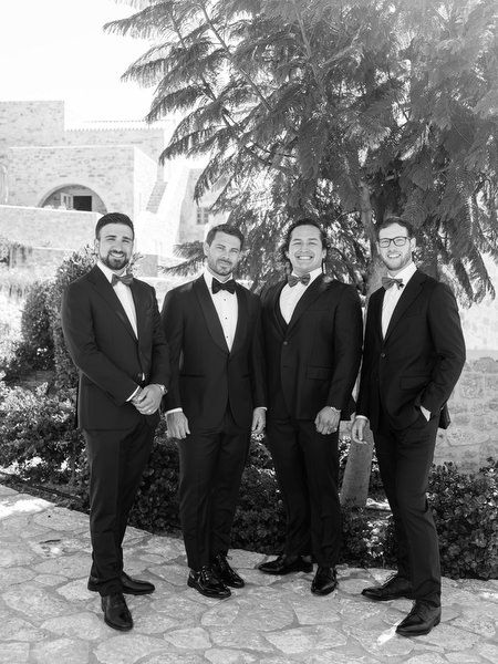 Black-and-white groomsmen portrait at Aria Estate wedding venue