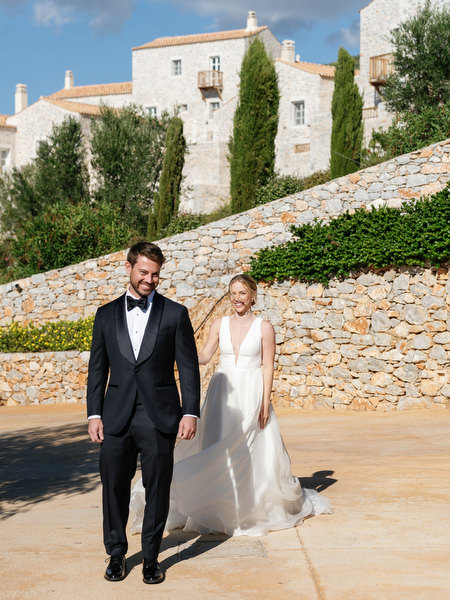 Bride and groom walking at Aria Estate wedding venue in the Peloponnese, Greece