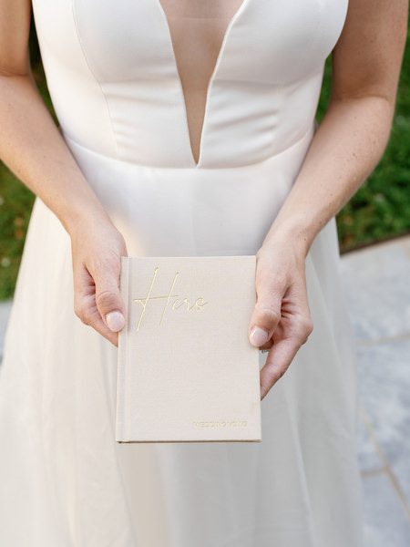 Bride holding wedding vows at Aria Estate wedding in Greece