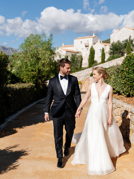 Bride and groom walking at Aria Estate wedding in the Peloponnese, Greece