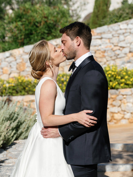 Romantic kiss during Aria Estate destination wedding in Greece
