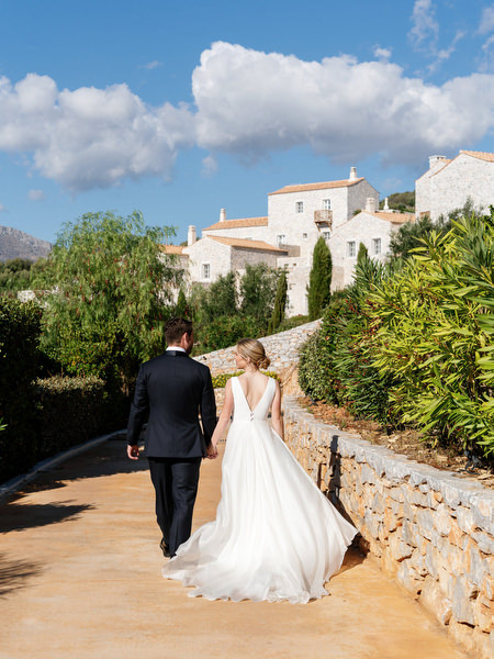 Bride and groom walking through Aria Estate grounds in the Peloponnese