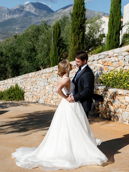 Bride and groom portrait with Peloponnese mountains at Aria Estate