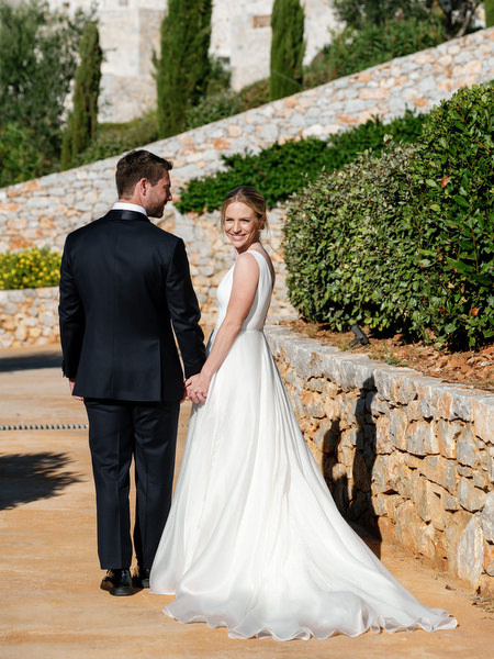 Bride and groom walking through Aria Estate stone courtyard