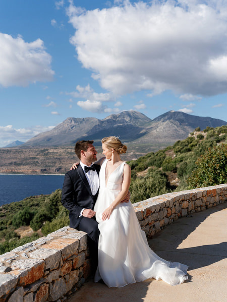 Bride and groom portrait with Peloponnese mountains at Aria Estate wedding venue