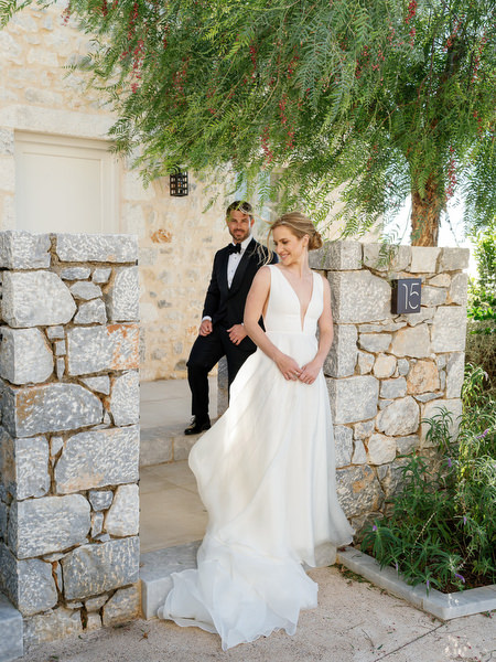 Bride entering Aria Estate courtyard during destination wedding in Greece