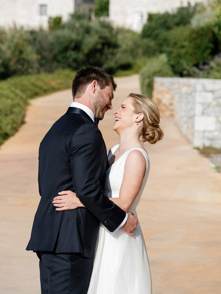 Bride and groom portrait on stone pathway at Aria Estate Greece