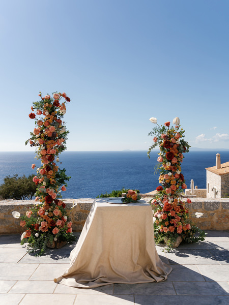 Floral ceremony arch overlooking the sea at Aria Estate wedding venue