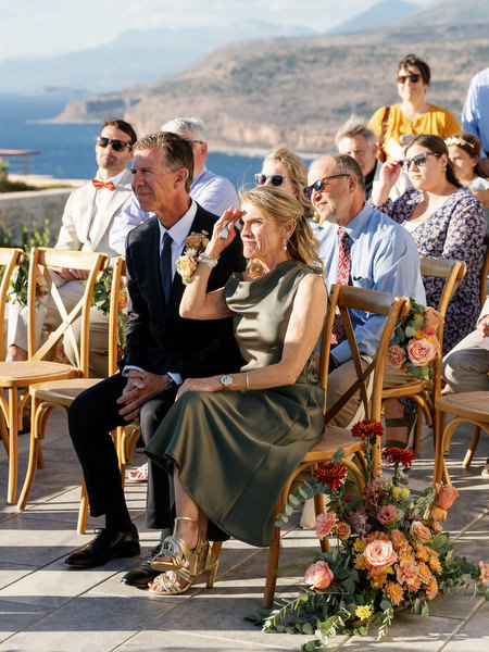 Parents watching ceremony at Aria Estate wedding with sea views