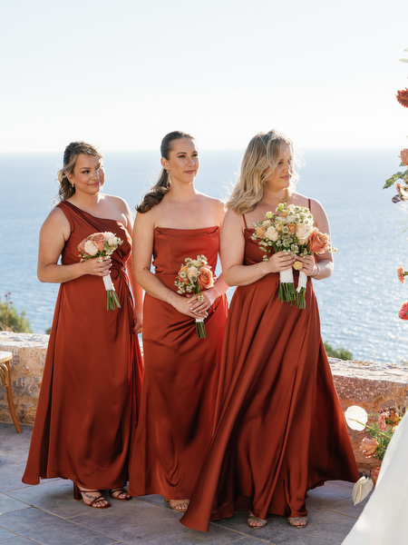 Bridesmaids in rust dresses at Aria Estate destination wedding in Greece