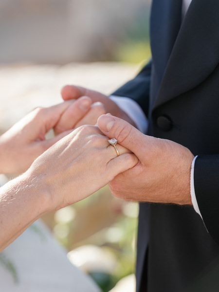 Close-up of wedding ring exchange at Aria Estate destination wedding