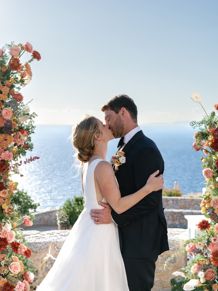 Romantic first kiss at Aria Estate destination wedding in the Peloponnese