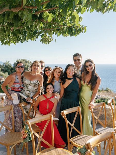Wedding guests group photo at Aria Estate overlooking the sea
