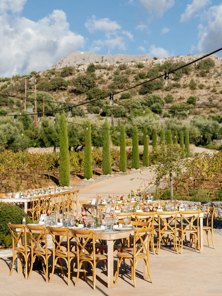 Outdoor wedding reception at Aria Estate overlooking vineyards in Greece
