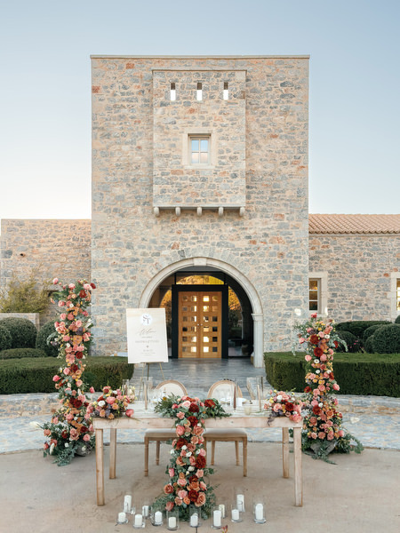 Floral ceremony setup at Aria Estate stone estate in Greece