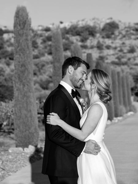 Romantic couple portrait on cypress-lined path at Aria Estate