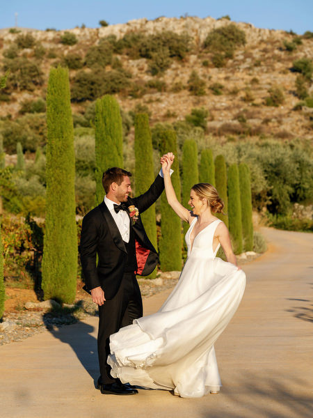 Bride twirling during golden hour at Aria Estate wedding in Greece