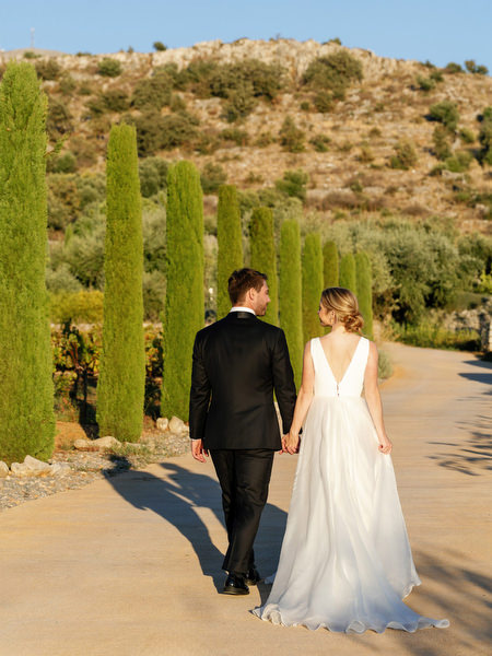Bride and groom walking at Aria Estate wedding venue in Greece