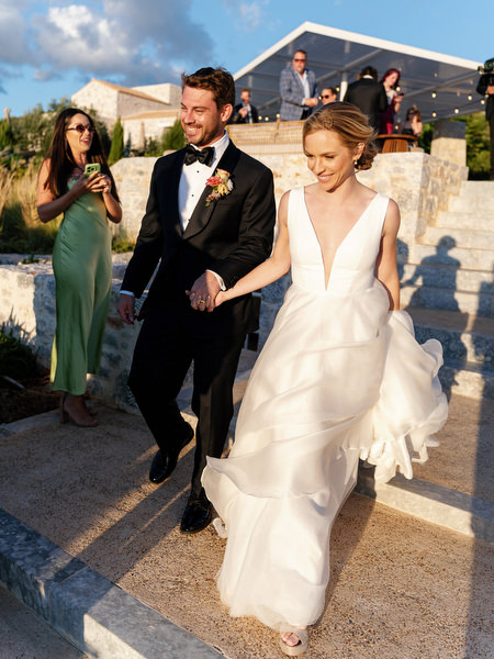 Bride and groom entering reception at Aria Estate wedding in Greece