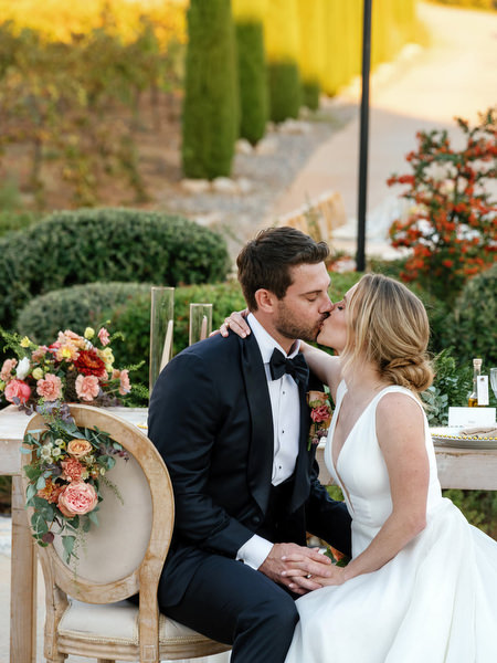 Bride and groom kissing at Aria Estate reception in Greece