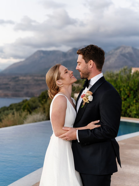 Bride and groom portrait at Aria Estate infinity pool at sunset