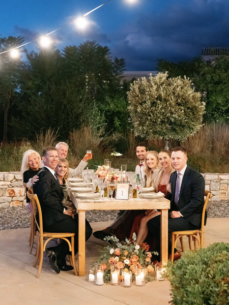 Outdoor wedding dinner under string lights at Aria Estate