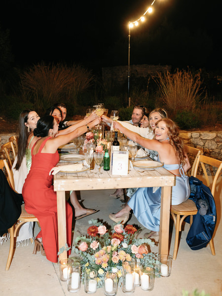 Wedding guests celebrating under string lights at Aria Estate