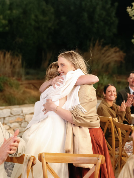 Wedding guest embracing during Aria Estate night reception