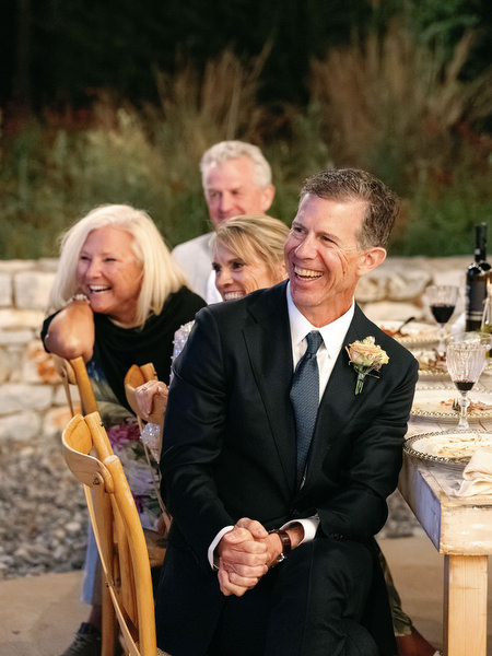 Wedding guest reacting during reception speech at Aria Estate