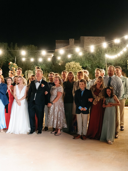 Wedding celebration under string lights at Aria Estate