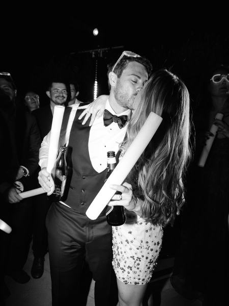 Bride and groom kiss during Aria Estate night party