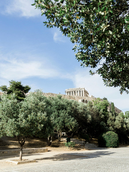Pre-wedding dinner under the Acropolis with ancient ruins and Parthenon view in Athens