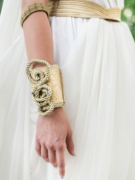 Grecian inspired wedding guest fashion detail with gold bracelet