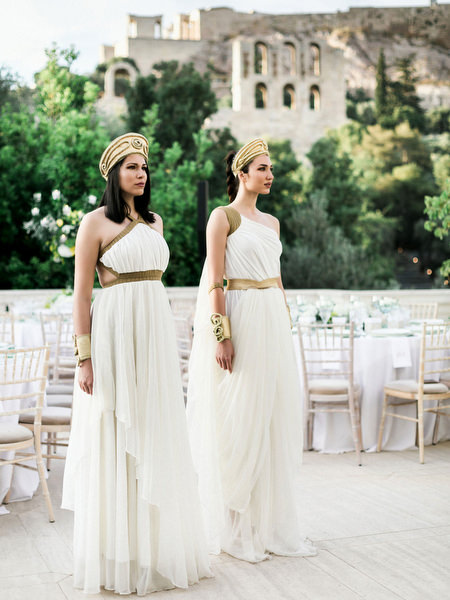 Guests in Grecian inspired outfits during Athens wedding welcome dinner