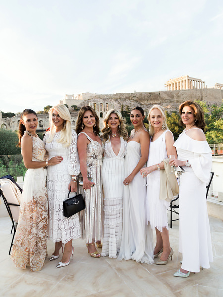 Guests in white posing during Athens pre-wedding dinner celebration