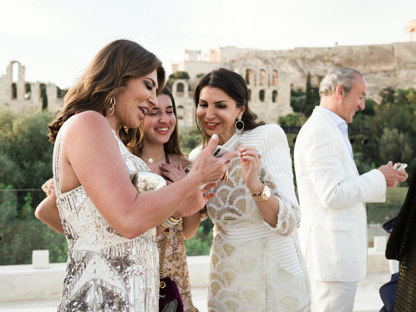 Friends laughing during Athens wedding celebration