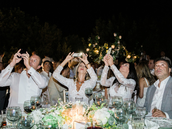 Guests cheering during Athens pre-wedding dinner celebration