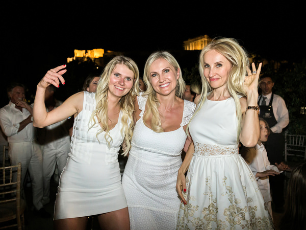 Female guests posing during Athens wedding welcome event